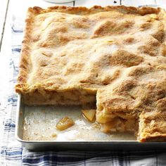 a close up of a pie in a pan on a table with a blue and white checkered cloth