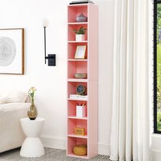 a pink book shelf in a white room