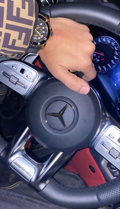 a person holding the steering wheel of a car