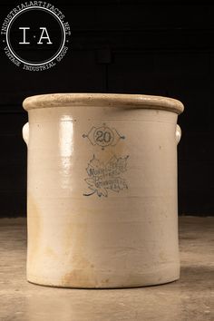 a large white pot sitting on top of a cement floor