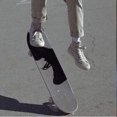 a person jumping in the air on a skateboard with their feet off the ground