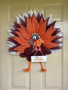 a door hanger with a turkey holding a sign that says horsie's