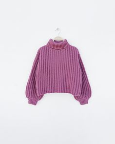 a purple turtle neck sweater hanging on a hanger, with the top half open