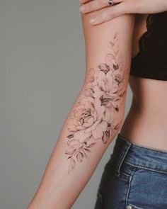 a woman with a flower tattoo on her arm