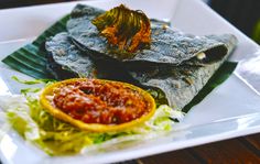 a white plate topped with food on top of a wooden table