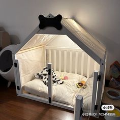 a bed with a dog bone on the top of it and a stuffed animal in the middle