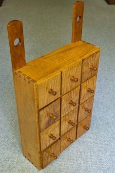 a small wooden cabinet with six drawers