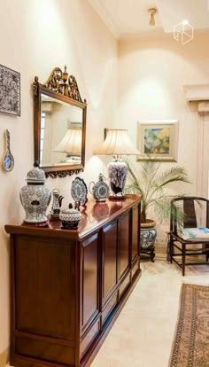 a living room filled with lots of furniture and vases on top of a wooden table