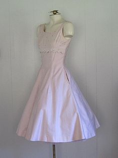 APPROXIMATE MEASUREMENTS (INCHES): Current Size: S Bust: 34 Waist: 25 Hip: FULL Length (shoulder to hem): 41 CONDITION Very Good. There are some extremely light spots on the back right panel of the skirt, and a pinpoint blue spot on the right/front hip (please see photos). DESCRIPTION 1950s pink cotton party dress Natlynn Junior Originals label Fitted bodice with full skirt Floral embroidery under bust Scattered rhinestones on bodice Pink Vintage Dress 1950s, Dress With Skirt, 1950s Pink Dress, Vintage Party Dress, How I Want To Dress, Fitted Feminine Dress For Vintage Events, A-line Cotton Vintage Dress For Party, Cotton A-line Vintage Dress For Party, Fitted Cotton Vintage Dress For Party