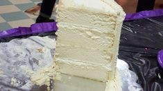 a piece of white cake sitting on top of tin foil next to a purple basket