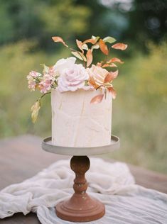 a white cake sitting on top of a wooden table