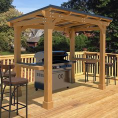 an outdoor bbq with grill and bar stools on a deck next to trees