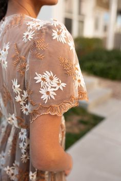 London is 5'8.5" and wearing a small - Runs TTS without stretch - size up if you need room in the bust - Elastic waist for comfortable fit - Incredible white and golden-brown embroidered floral overlay - Scalloped hem and edges of the sleeve - Fully lined and so unique! Product Measurements*Measurements are taken from side seam to side seamwhile laying flat. Small: Length: 44" Bust: 15" Waist: 14" Medium: Length: 44.5" Bust: 16" Waist: 15"Large: Length: 45" Bust: 17" Waist: 16"X-Large: Length: 4 Floral Embroidered White Dress, Floral Overlay, Scalloped Hem, Golden Brown, Embroidered Dress, Medium Length, Elastic Waist, Comfort Fit, White Dress