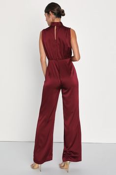 You'll feel like total royalty in the Lulus Classic Elegance Wine Red Satin Sleeveless Mock Neck Jumpsuit! Luxe woven satin shapes this chic jumpsuit that has a mock neckline and a sleeveless bodice with gathered fabric detailing. Fitted waist tops wide legs that end at ankle-length hems. Keyhole opening and double button closure at back. Hidden back zipper/clasp. Fit: This garment fits true to size. Length: Floor length. Size medium measures 61.5" from shoulder to hem. Inseam: 32.00 Front Rise: Red Velvet Jumpsuit Outfit, Burgundy Velvet Jumpsuit, Red Velvet Jumpsuit, Red Fitted V-neck Jumpsuit, Burgundy Jumpsuit, Satin Jumpsuit, Adhesive Bra, Jumpsuit Chic, Lulu Fashion