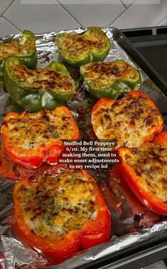 stuffed bell peppers with cheese and seasoning on them in an oven tray, ready to be cooked