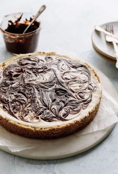 a cheesecake on a plate with chocolate sauce