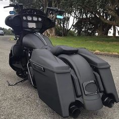 a black motorcycle is parked on the side of the road