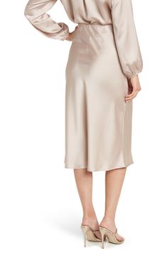 Elevate your wardrobe with this pull-on bias satin midi skirt for elegant, feminine style. 31" length (size S) Elasticized waist Pull-on style Satin construction 97% polyester, 3% spandex Machine wash cold, line dry Made in USA Model’s stats for sizing: 5’10” height, 34” bust, 27” waist, 35” hips. Model is wearing size S. Feminine Satin Skirt For Formal Occasions, Feminine Formal Satin Skirt, Formal Feminine Satin Skirt, Satin Midi-length Bottoms For Work, Relaxed Satin Pencil Midi Skirt, Spring Evening Midi Length Pencil Skirt, Relaxed Fit Satin Midi Pencil Skirt, Satin Midi Bottoms For Workwear, Satin Midi-length Bottoms For Spring