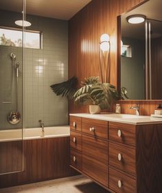 a bath room with a sink a mirror and a bath tub