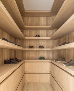 there are many pairs of shoes on the shelves in this walk - in shoe closet