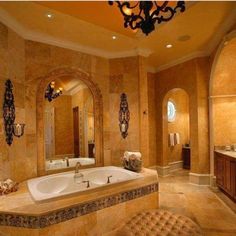 a large bathroom with an oval tub and chandelier