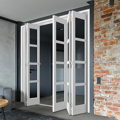 an open room with two doors and brick wall