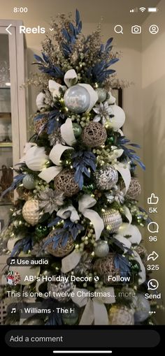 a christmas tree decorated with blue and white ornaments is featured on the iphone app's home screen