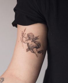 a tattoo on the arm of a person with a cupid holding a bow and arrow