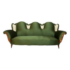 a green couch sitting on top of a white floor