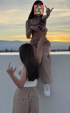 two women standing next to each other in front of a tv