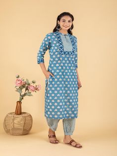 Blue dabu flower printed straight kurta, has a mandarin collar, mirror and katha embroidered yoke, three-quarter sleeves and stripes Print afgani Pants has Elasticated Waistband Fabric: 100% Cotton Color: Blue Note: Available in other colors Wash Care Instruction - Dry Clean Only The product will be shipped within 15-20 days of order placed Size Chart: Kurta Size XS S M L XL XXL XXXL Bust 36 38 40 42 44 46 Waist 32 34 36 38 40 42 Hip 38 40 42 44 46 48 Shoulder 14 14.5 15 15.5 16 16.5 Armhole 18 Cotton Tunic Kurta With Relaxed Fit, Cotton Kurta With Resham Embroidery For Transitional Season, Cotton Bandhani Print Sets For Spring, Casual Bandhani Print Kurta For Festivals, Traditional Tunic Kurta With Relaxed Fit, Long Sleeve Cotton Traditional Wear With Printed Motifs, Transitional Cotton Salwar Kameez, Casual Bandhani Print Kurta For Festive Occasions, Casual Bandhani Print Festive Kurta