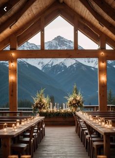 an outdoor dining area with wooden tables and mountain view