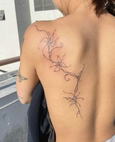 the back of a woman's shoulder with flowers on it