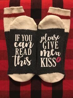 two socks that say if you can give read me a kiss