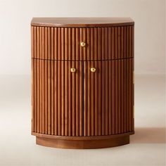 a wooden cabinet with brass knobs on the top and bottom, against a white background