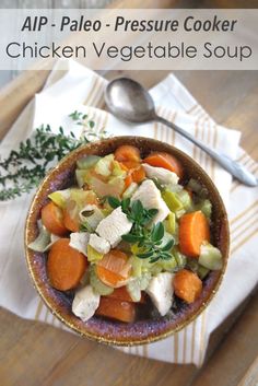 a bowl filled with carrots, celery and meat on top of a wooden table