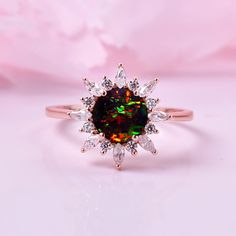 an opal and diamond ring on a pink background