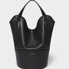 Returns Taking Its Name From The Stingray, Whose Shape It Mimics, The Small Ray Bucket Bag In Black Is A Bucket Bag Made From Two Types Of Leather; The Bottom Is Made From Small Grain And Is Lined With Suede Which Is Both Durable And Provides Texture, And The Upper Area Is Made From Unlined Smooth Calf With A Suede Finish, Allowing The Bag To Be Folded And Carried Under The Arm, Clutch Style. Smaller Than Our Iconic Ray Bucket, The Bag Can Accommodate A 13” Laptop As Well As Everyday Essentials. Classic Black Bucket Bag With Top Carry Handle, Classic Black Bucket Bag With Top Handle, Luxury Formal Bucket-shaped Bag, Classic Evening Bucket Bag With Leather Handles, Designer Black Bucket Bag With Double Handle, Designer Black Bucket Bag With Top Handle, Designer Bucket Hobo Bag For Evening, Classic Bags With Detachable Handle In Bucket Shape, Luxury Bucket Hobo Bag For Travel