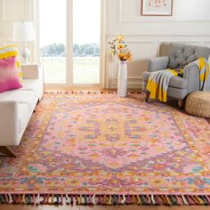 a living room filled with furniture and a colorful rug