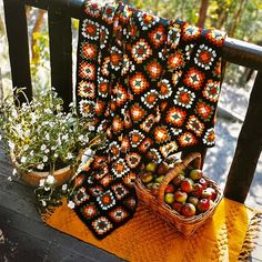 two baskets filled with fruit sitting on top of a wooden bench