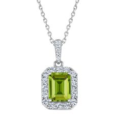 Vivid in color, this gemstone pendant necklace will add a luxuriant touch to any jewelry collection. Crafted in sterling silver, this pendant features an emerald-cut green peridot gemstone that is surrounded by round created white sapphire gemstones. Additional created white sapphires line bail of the pendant, for extra glisten and shine. The side of the pendant is decorated with a round peridot inside a heart detail and flourishing swirls, for a sweet surprise when viewed at an angle. This pend Green Emerald-cut Gemstone Accent Jewelry, Green Emerald Cut Jewelry With Gemstone Accents, Emerald Cut Green Gemstone Jewelry, Fine Jewelry Lime Green Gemstone, Emerald Cut Peridot Gemstone Jewelry, Green Peridot Necklace In Fine Jewelry Style, Elegant Green Peridot Birthstone Necklace, Green Pendant Gemstones For Formal Occasions, Elegant Lime Green Gemstone Necklace