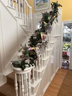 the stairs are decorated with garland and pine cones