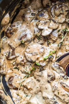 a pot filled with mushrooms covered in gravy