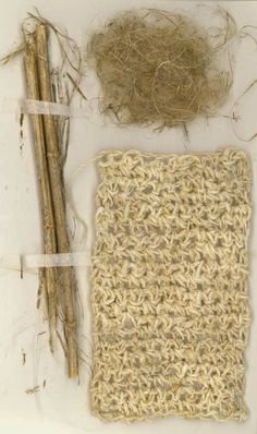 two pieces of yarn and sticks on a white surface