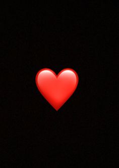 a red heart is glowing in the dark