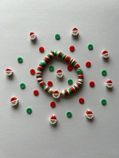 a bracelet made out of plastic beads and candy canes on top of a white surface