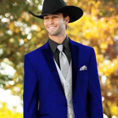 a man wearing a blue suit and black hat