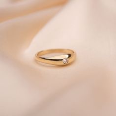 a gold ring with a diamond on it