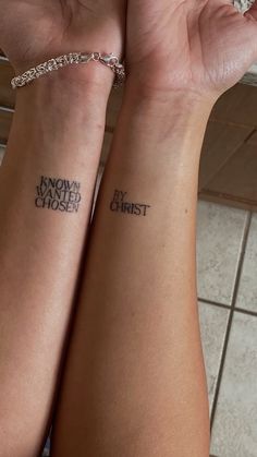 two people with matching tattoos on their arms, one has the words snow and christ