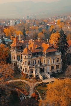 an aerial view of a mansion in the fall